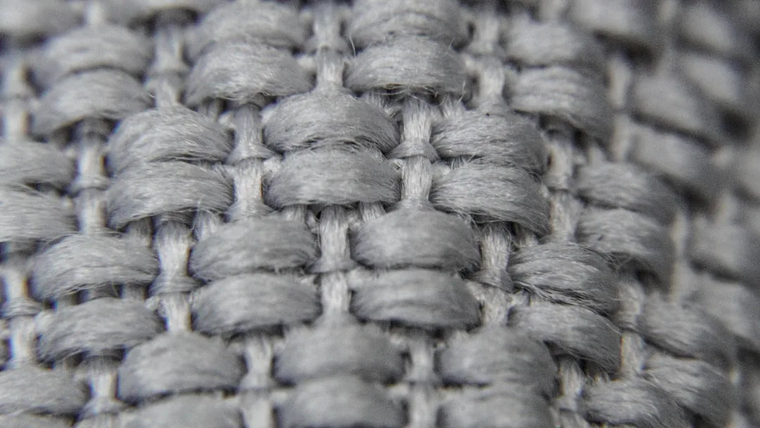 Pet-friendly sofa fabric in neutral tone with visible weave texture and protective coating