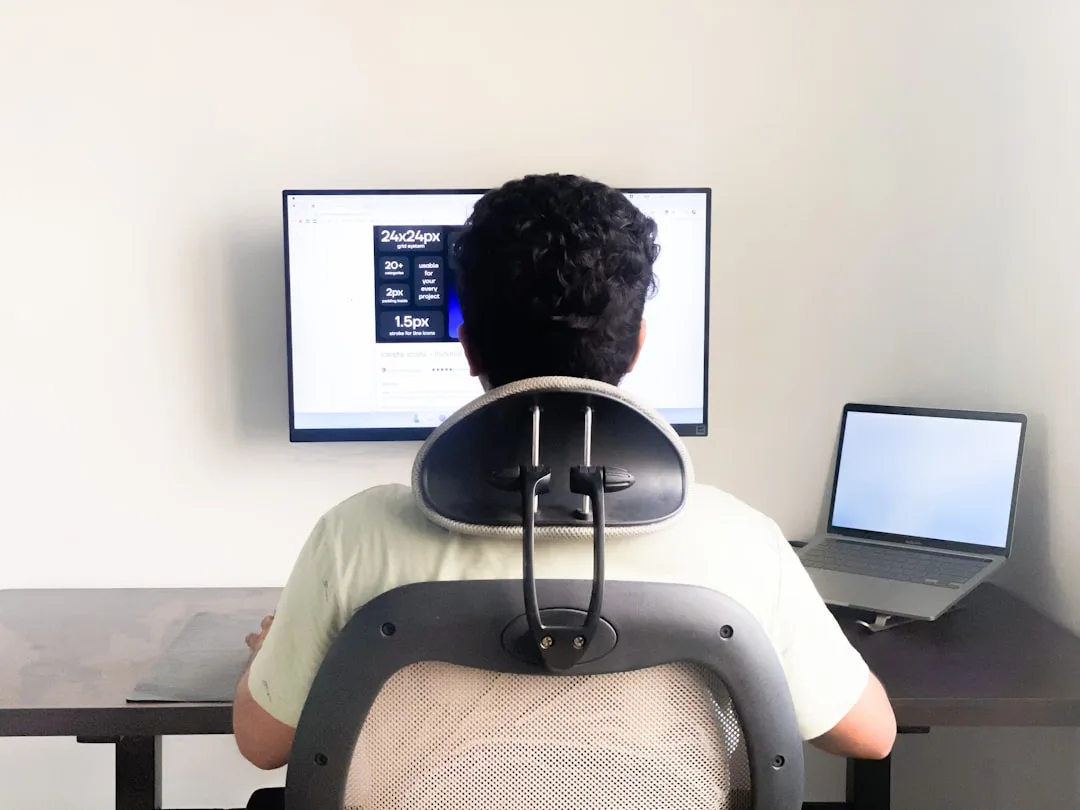 close-up of smart posture sensor attached to upper back showing LED indicators
