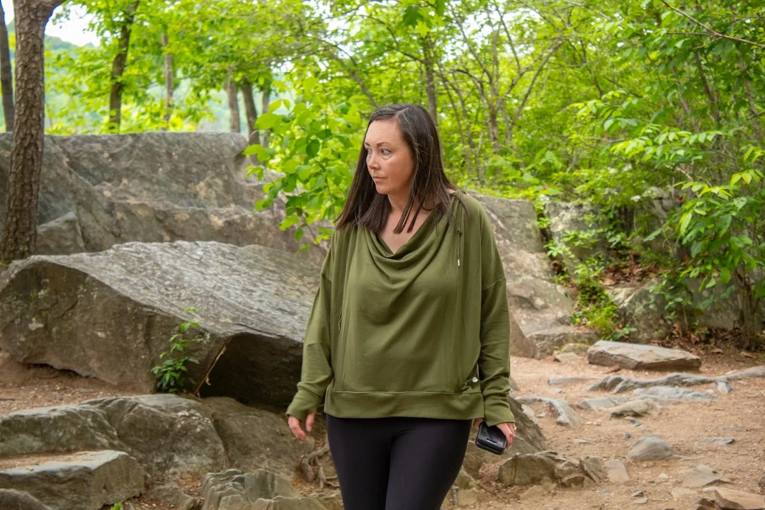 Woman performing Japanese walking interval training on outdoor trail with natural landscape