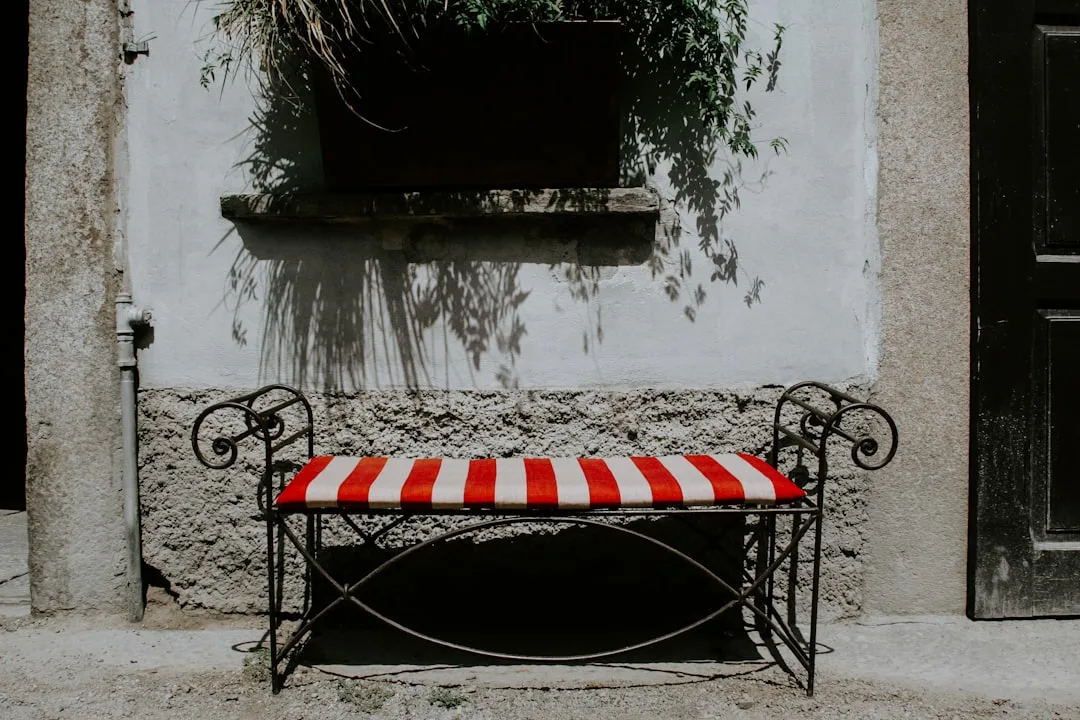 Outdoor storage bench with open lid revealing organized patio cushions