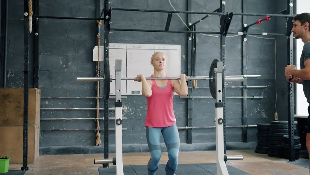 Woman in her fifties performing a controlled deadlift with focus on technique