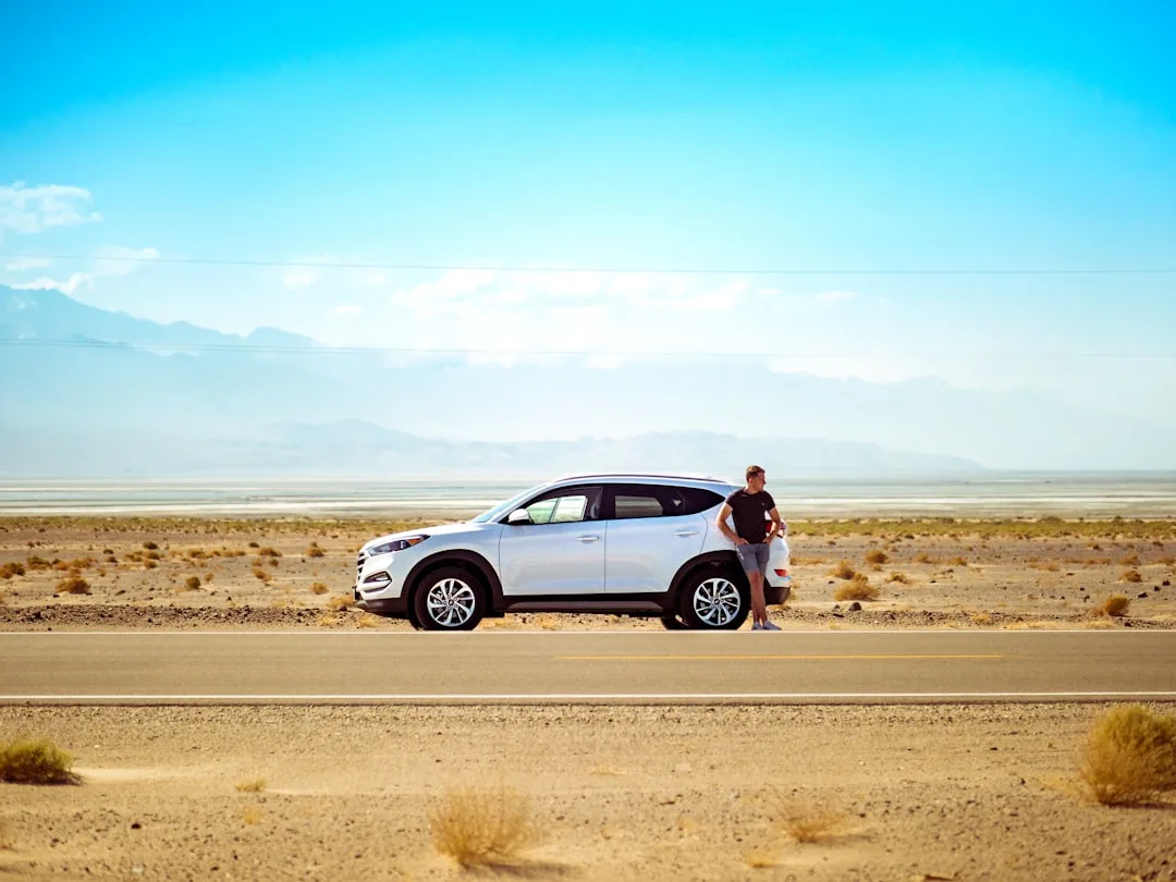 Young professional comparing flexible car loan options on tablet with financing advisor