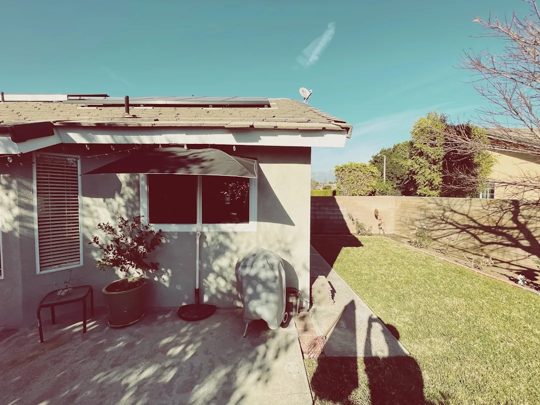 Detached ADU cottage in backyard garden setting with privacy fence