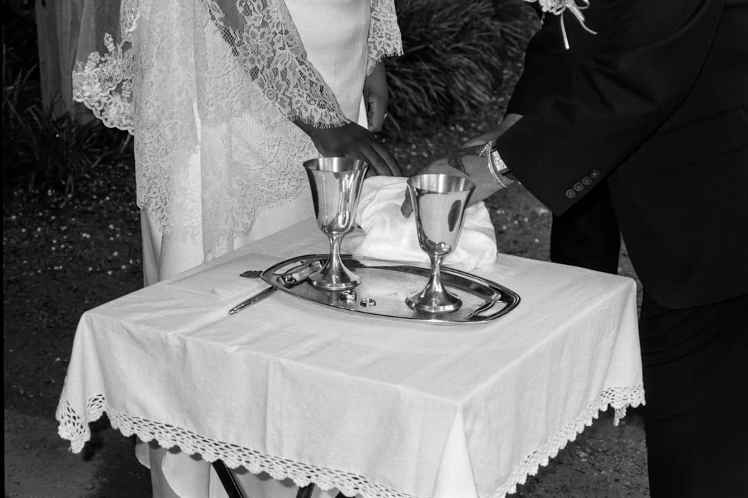 couple performing handfasting unity ritual — perspective 1