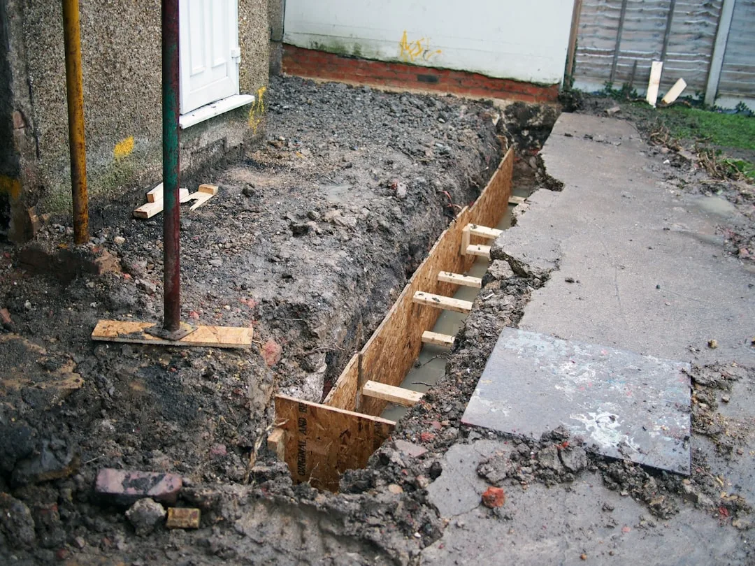 Interior basement drain tile system with perforated pipe and gravel base