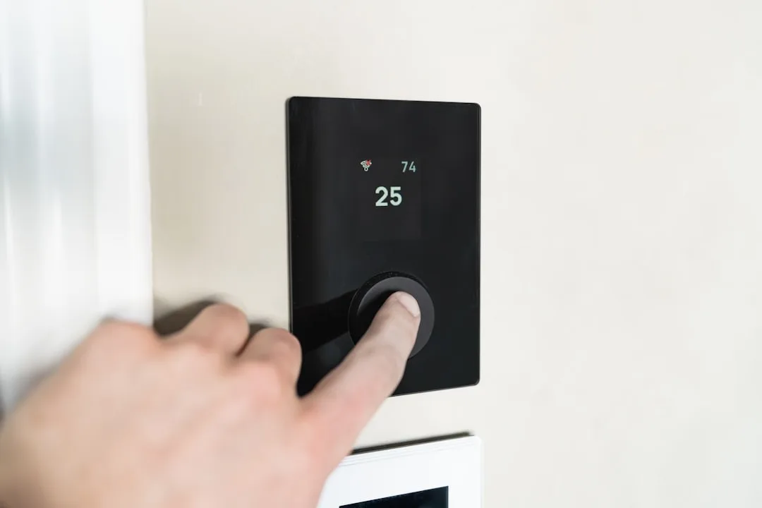 Smart ambient temperature sensor mounted on nightstand showing sleep-phase thermal tracking