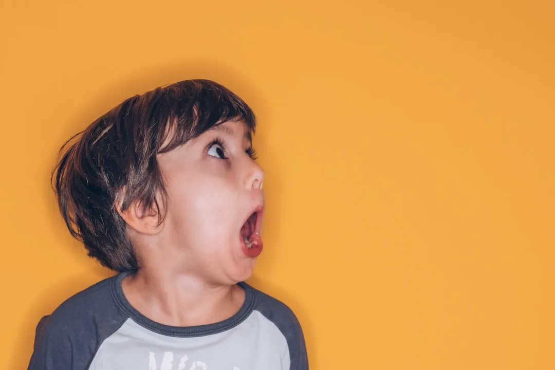 therapist teaching young child emotional vocabulary with color-coded feeling cards