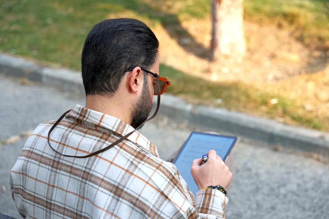 office worker receiving haptic feedback alert from posture wearable during desk work