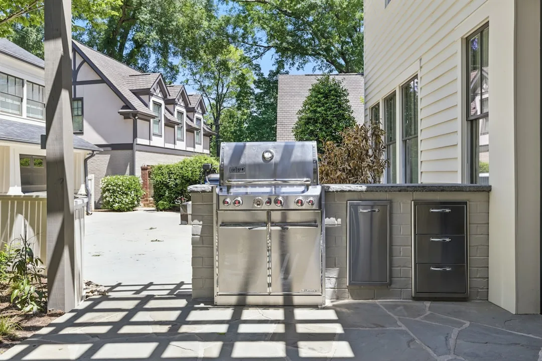 Stainless steel outdoor kitchen island featuring integrated grill and storage