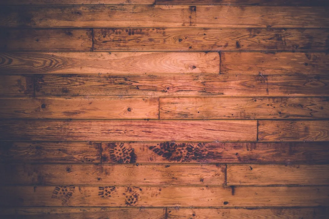 Before and after hardwood floor refinishing showing restored surface