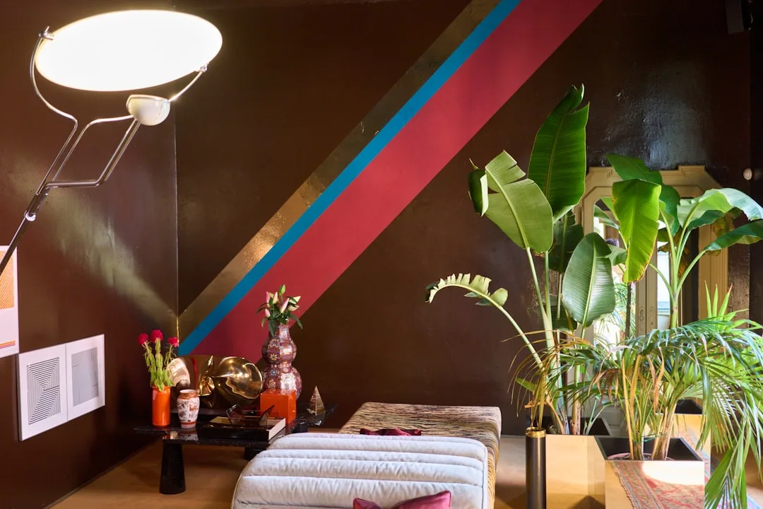 Home office featuring terracotta accent wall with wooden desk and shelving