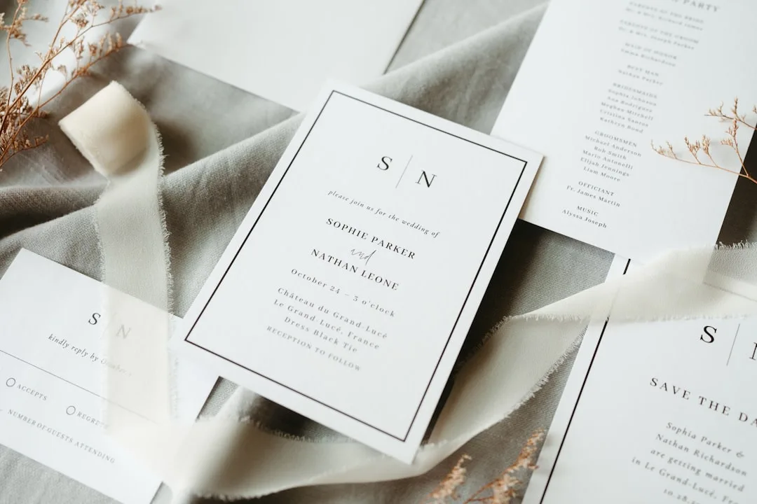 Wedding invitation with layered vellum, pressed flowers, and kraft paper components