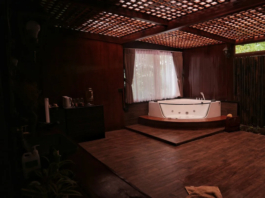 Tranquil wellness room with curved furniture, warm lighting, and natural stone textures for calming home sanctuary design