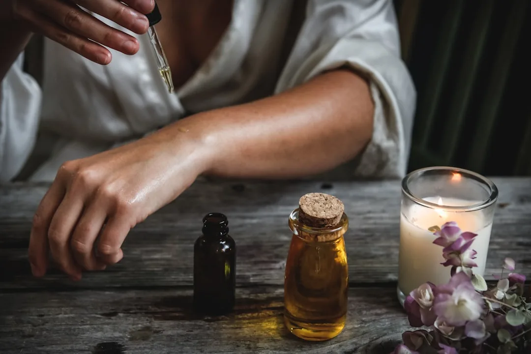 Woman applying facial oil layering technique to damp skin in layers