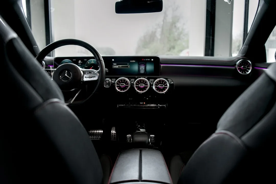 Luxury car cabin with custom leather seating and programmable ambient lighting system