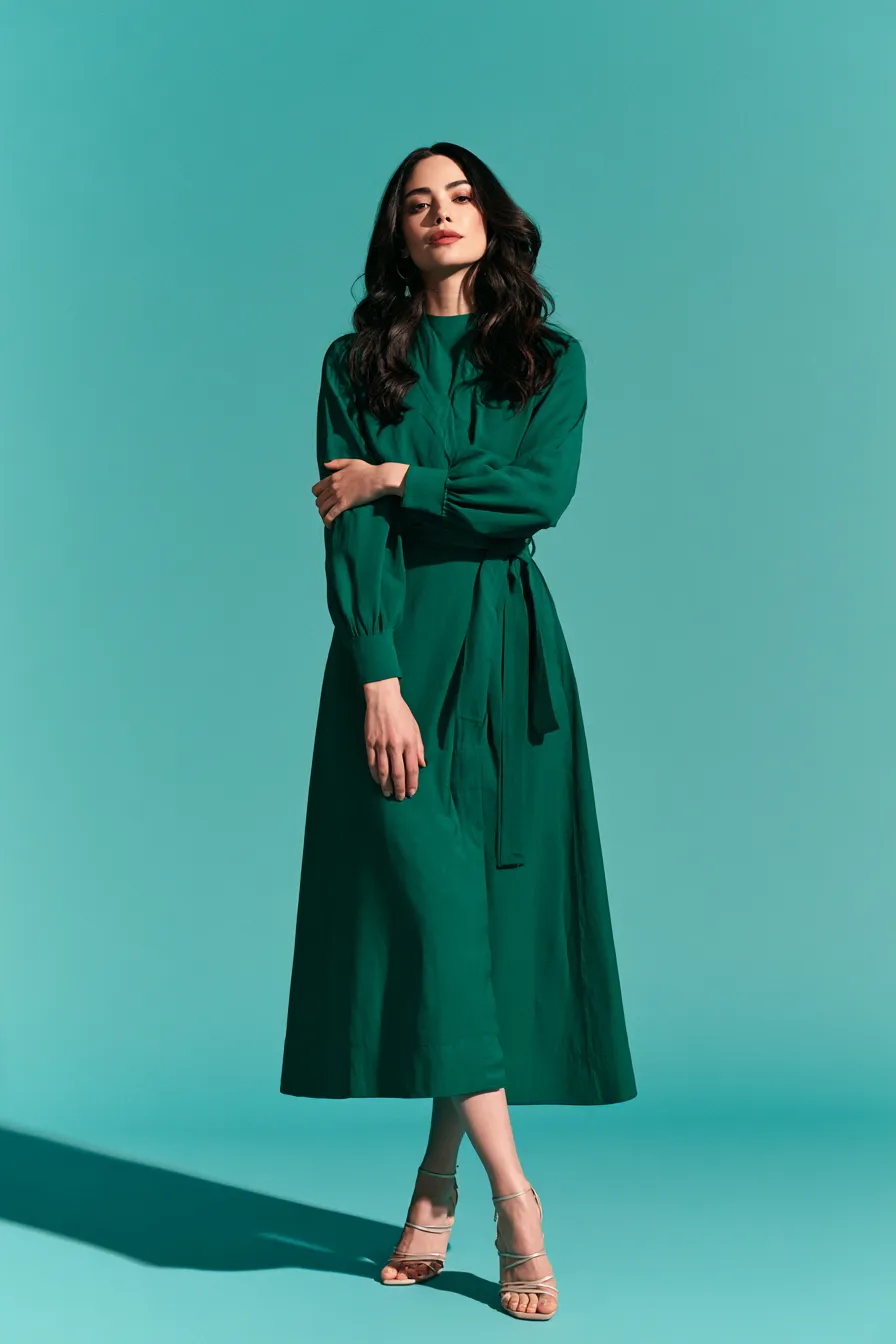 Core wardrobe dress for 30s women wrap silhouette in jewel tone standing shot