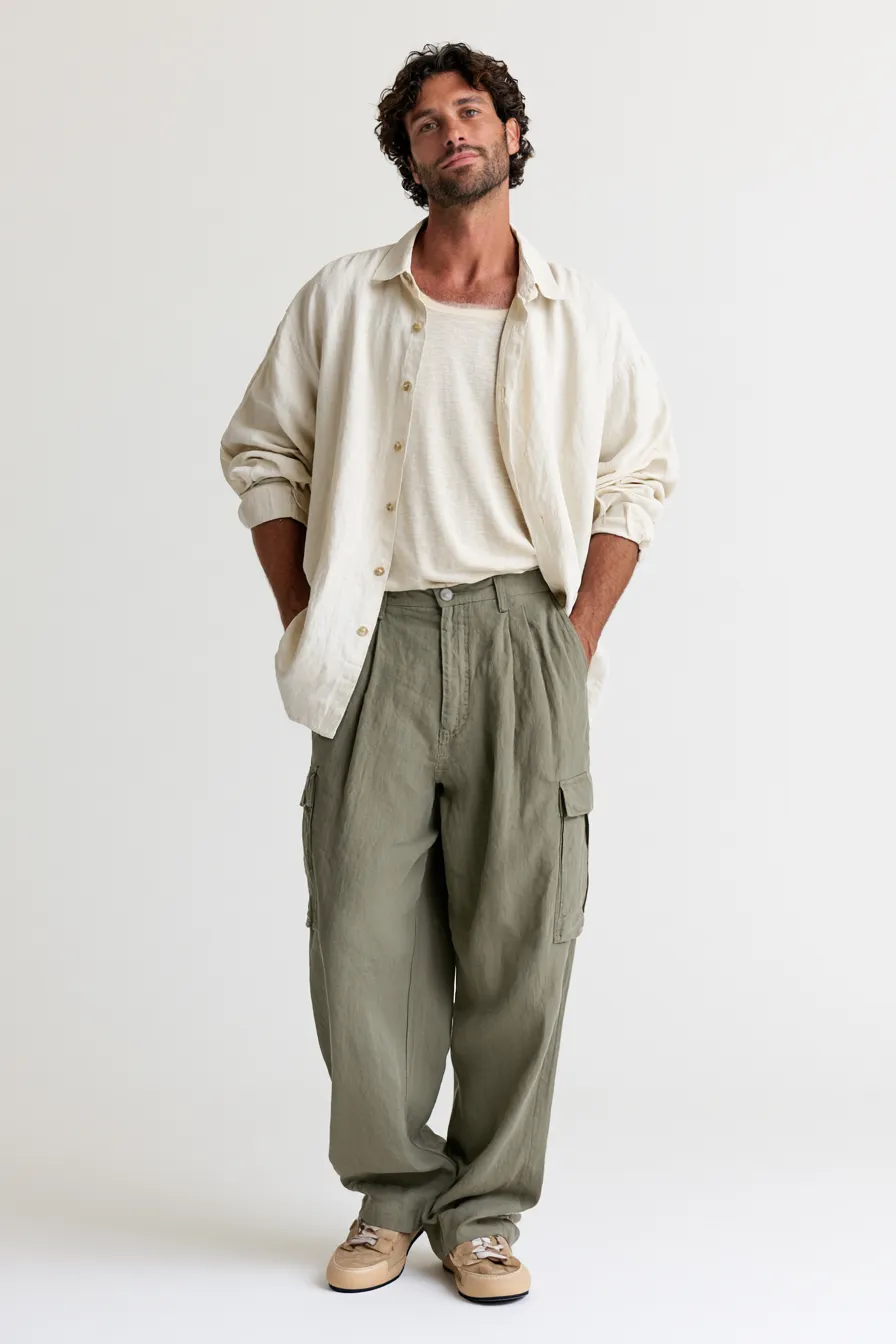Men's everyday casual outfit idea with utility pants and linen top photographed in a fashion catalog studio