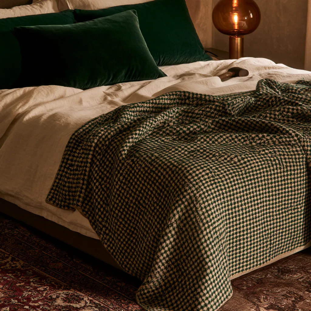 dark academia bedroom decor layered textiles houndstooth throw warm lamp