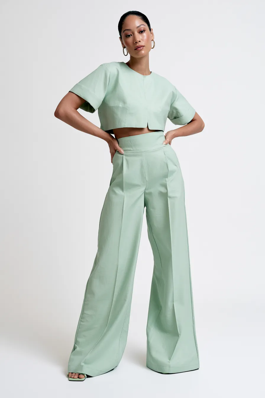 Female model wearing soft fashionable green mint co-ord in studio catalog shot