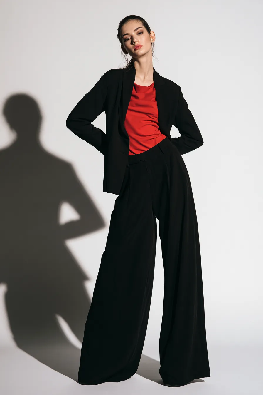 editorial red and black fashion styling on female model standing in studio