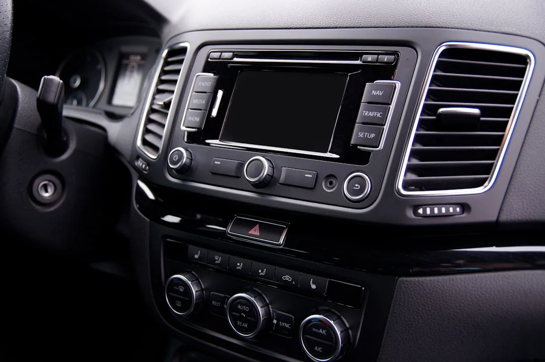luxury car dashboard with curved infotainment screen showing navigation and climate controls