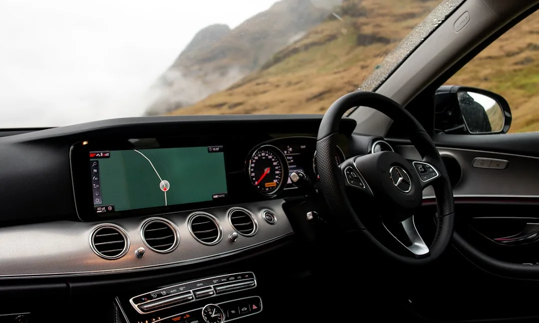 driver using voice command on modern vehicle infotainment system during commute