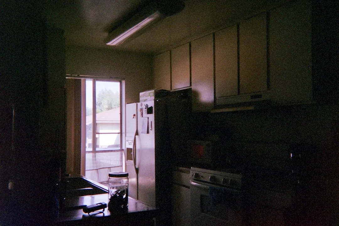 Full kitchen view displaying refinished cabinets paired with updated hardware and lighting