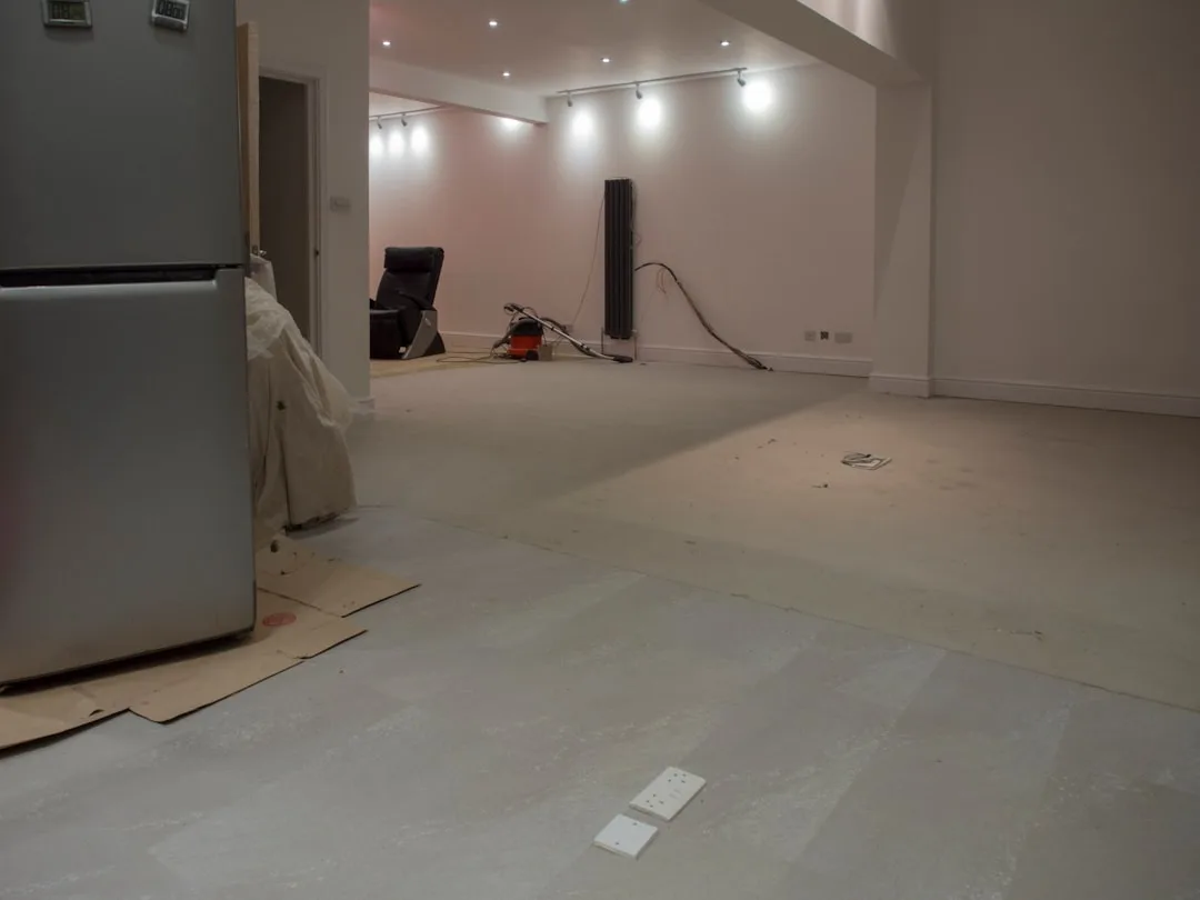 Professional application of two-part epoxy resin onto concrete basement floor