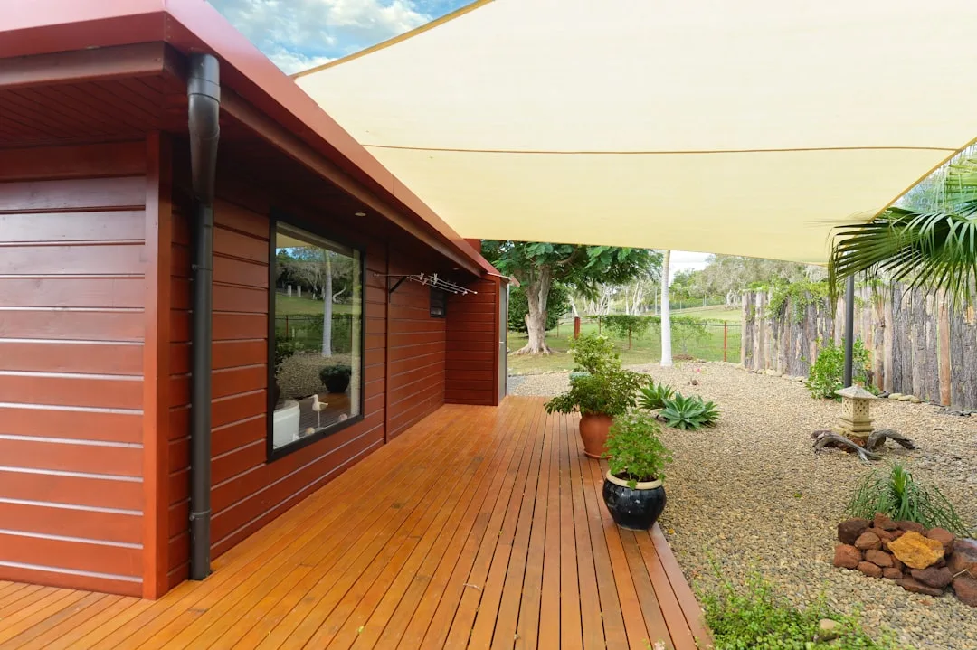 tilting cantilever outdoor patio umbrella with marine-grade fabric over lounge seating