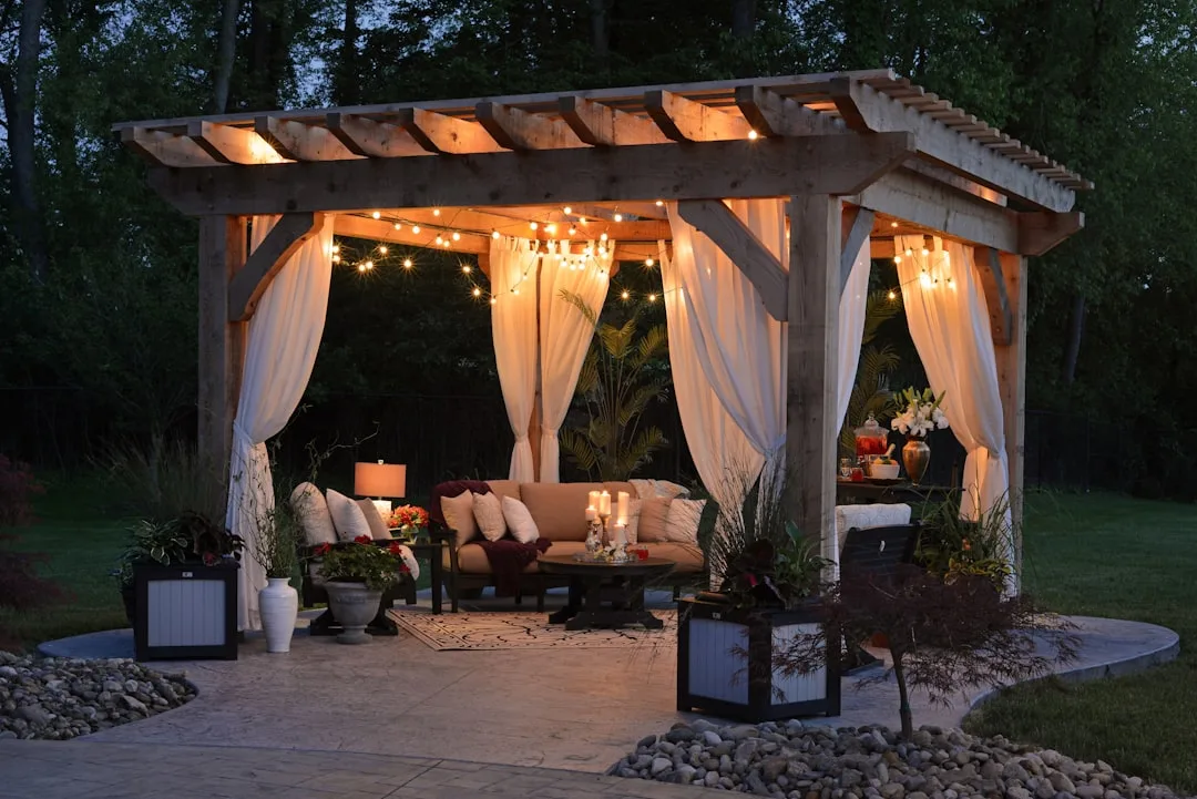 Modern patio with warm accent lighting on stone walls and landscape features