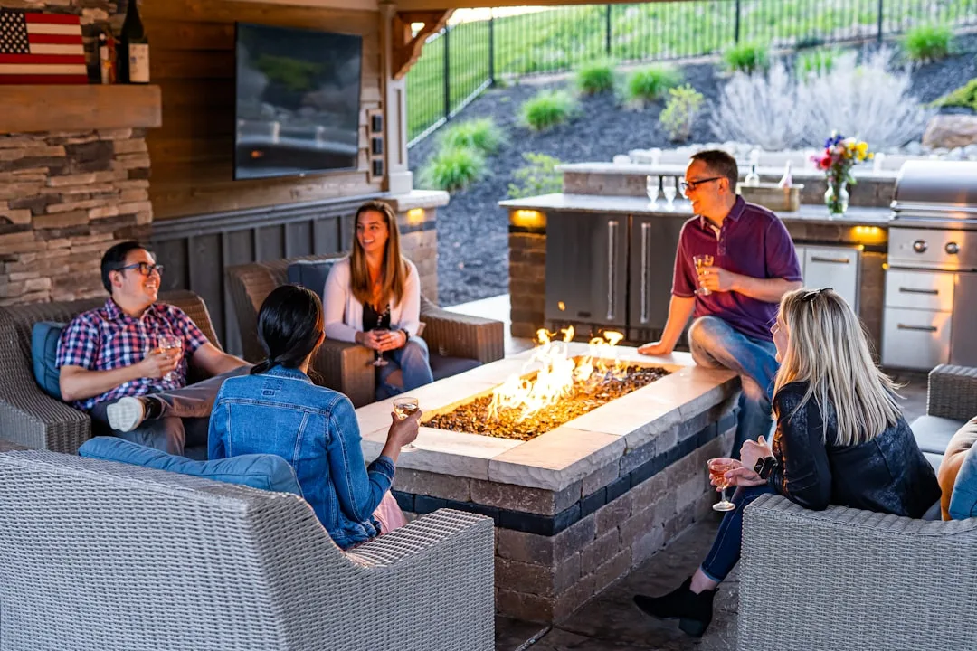 Stainless steel outdoor kitchen appliances built into modern patio cooking zone