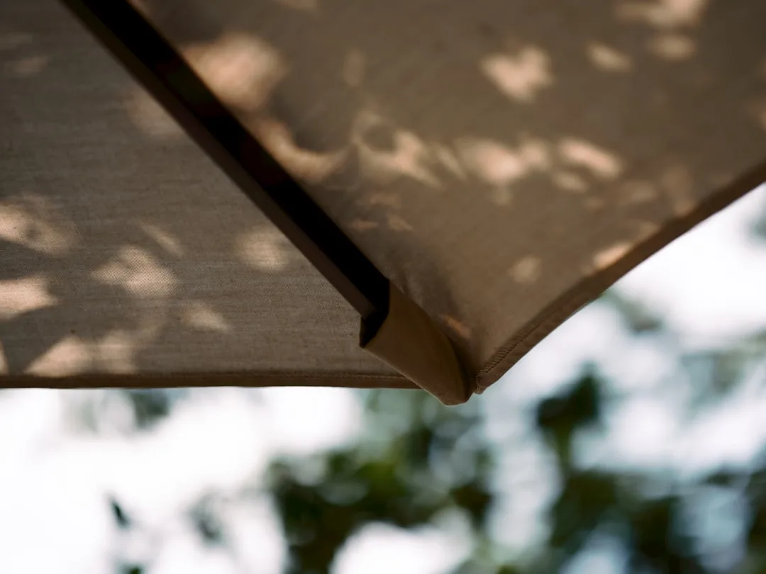 modern outdoor patio umbrellas providing shade over seating area