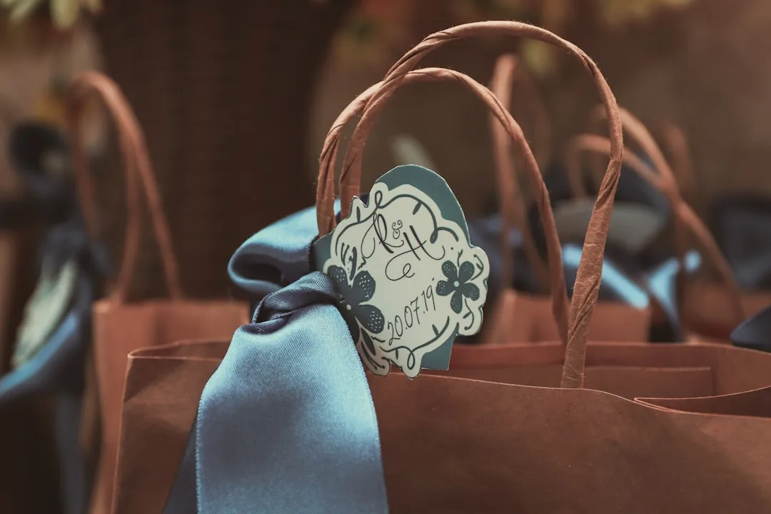 Curated wedding welcome bags featuring locally-sourced items and personalized packaging on white linen table