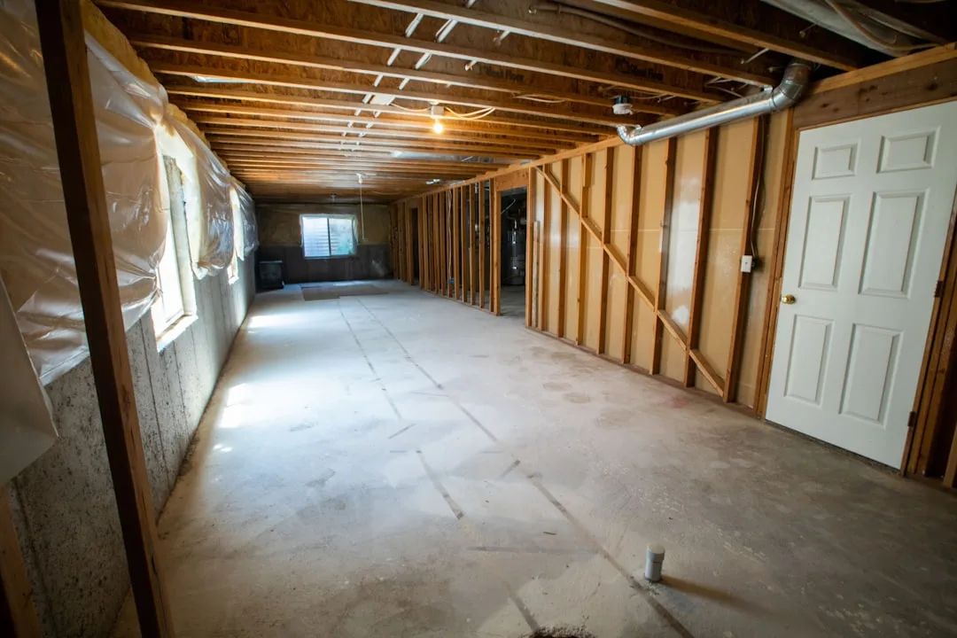 Whole-home basement dehumidification unit with ducting and condensate drain
