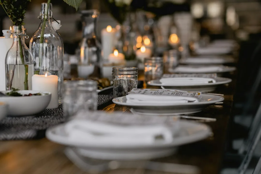 Candlelit dinner party table with place cards and mixed guest seating