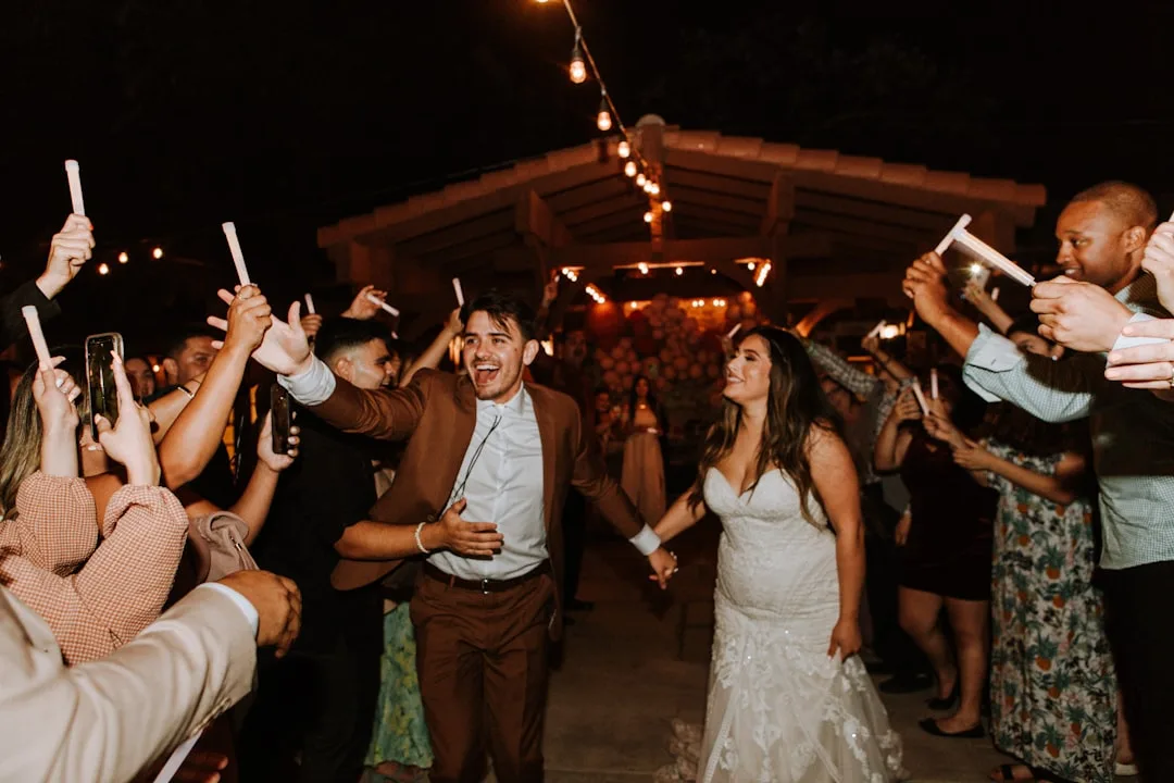 Diverse wedding guests contributing song requests to digital wedding guest playlist