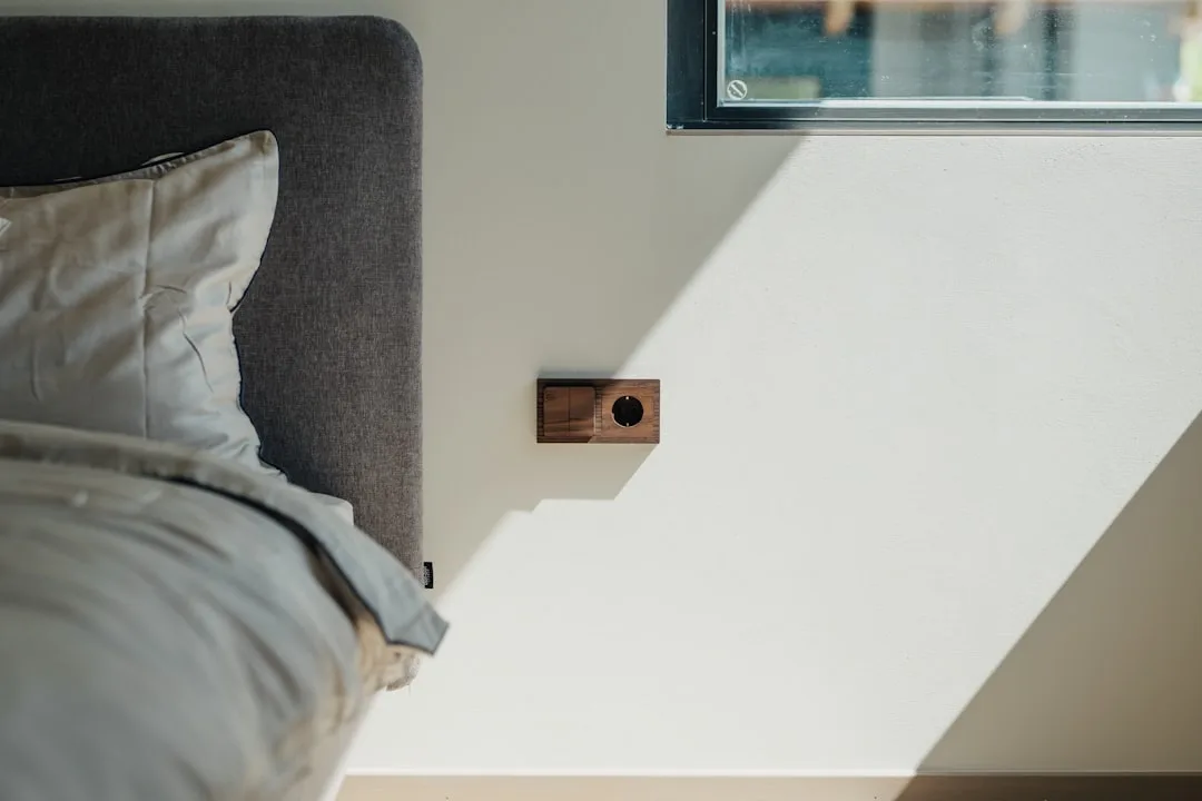 Compact ambient sensor device displaying real-time light and sound levels near bed