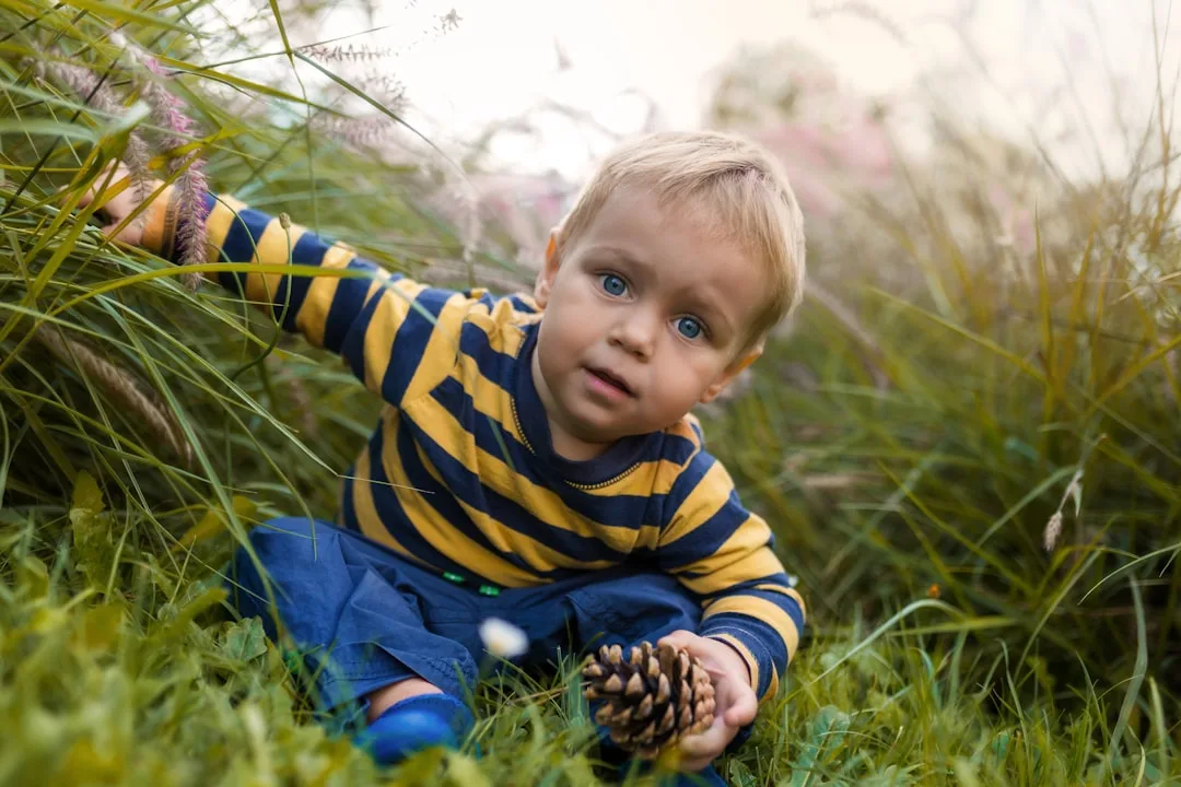 child wading creek water with bare feet during outdoor sensory play