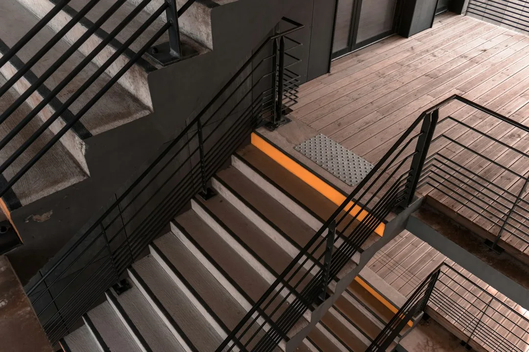 Close-up of aluminum stair nosing covering worn wooden tread edge