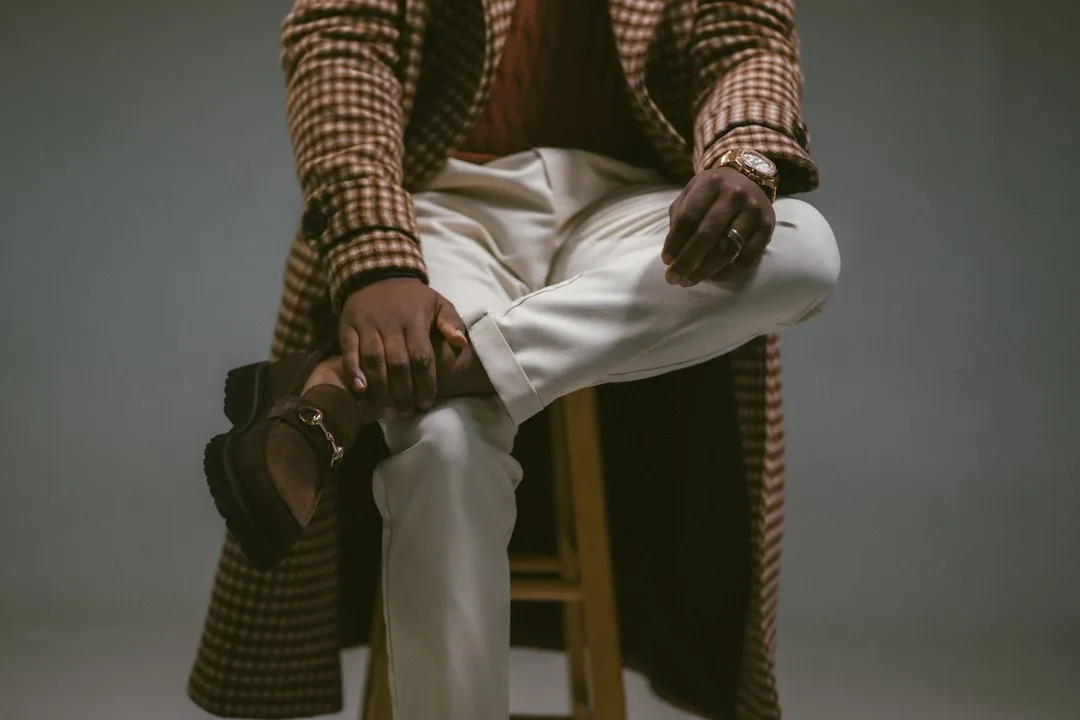 Man wearing quiet luxury menswear silhouettes in neutral tones and structured fit