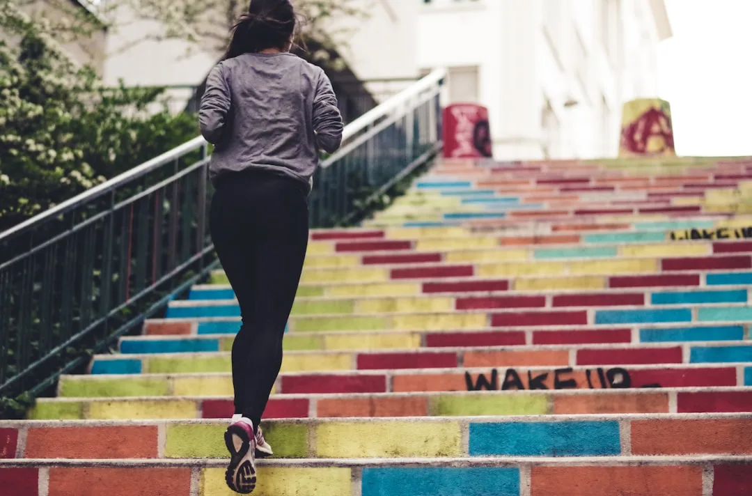 woman performing stair climbing workout on indoor staircase