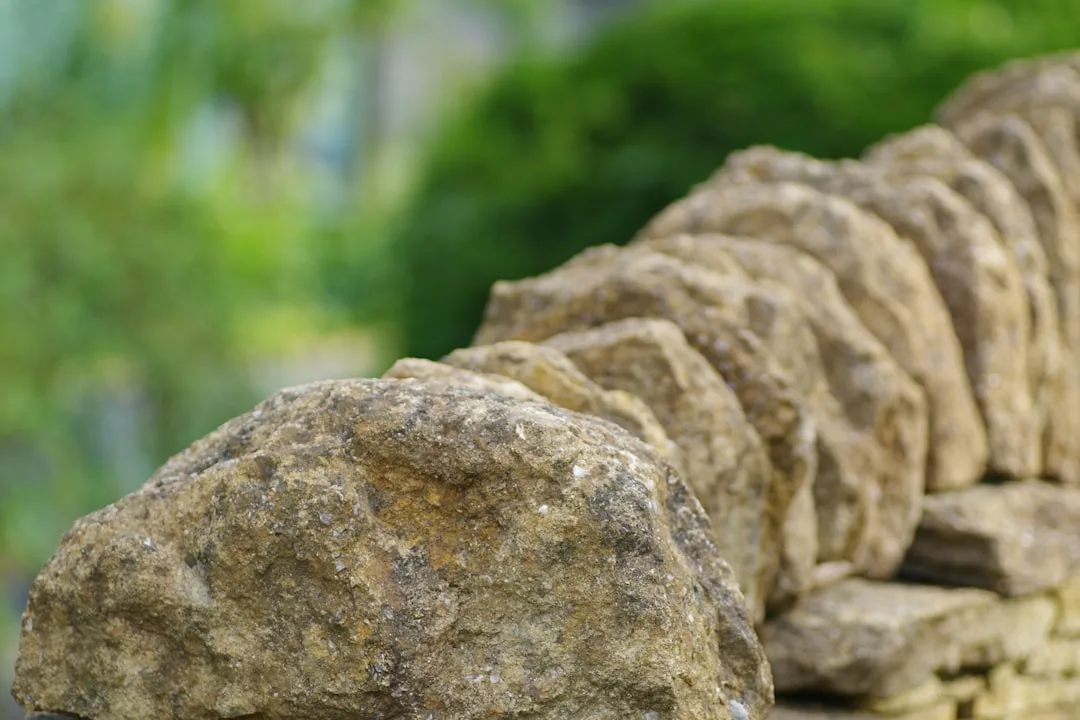 Granite and slate natural stone borders framing raised garden beds
