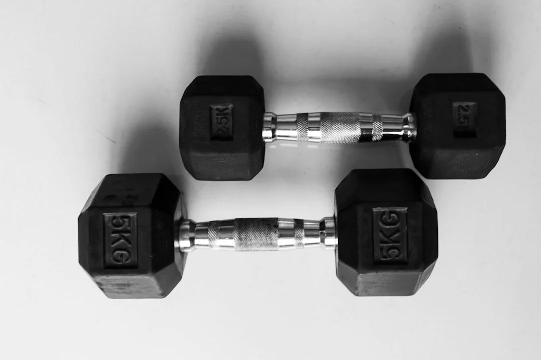 Man performing concentric strength training with controlled dumbbell press movement