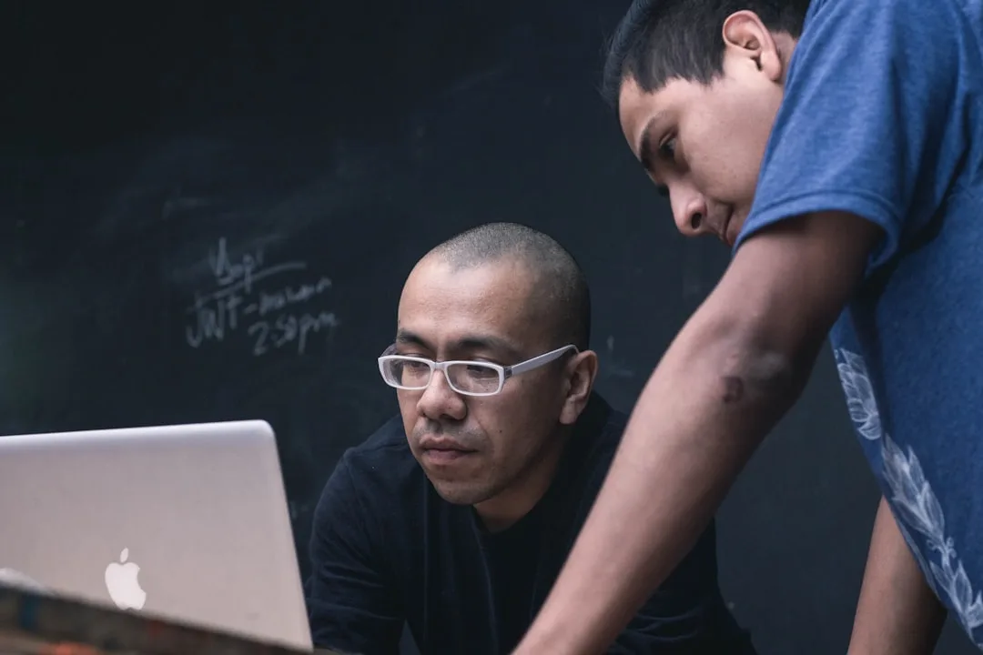 Live coding bootcamp mentor reviewing real-time code feedback with student