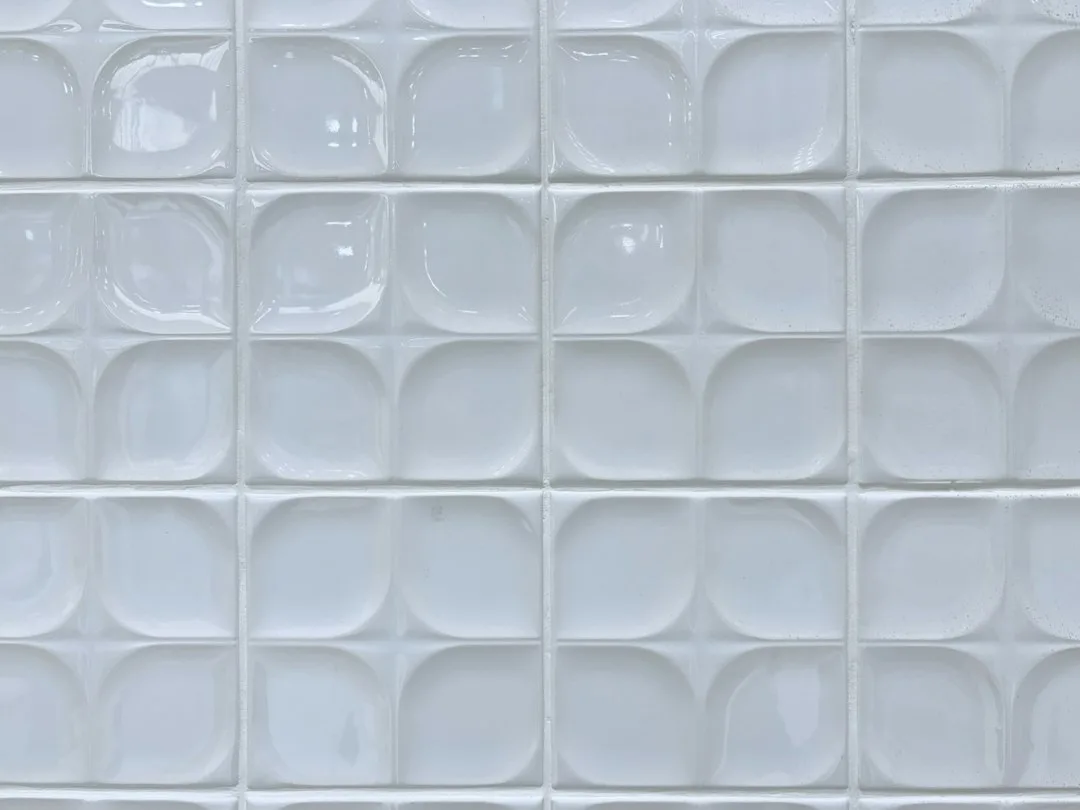 Large-format porcelain tile accent wall with marble veining in contemporary kitchen