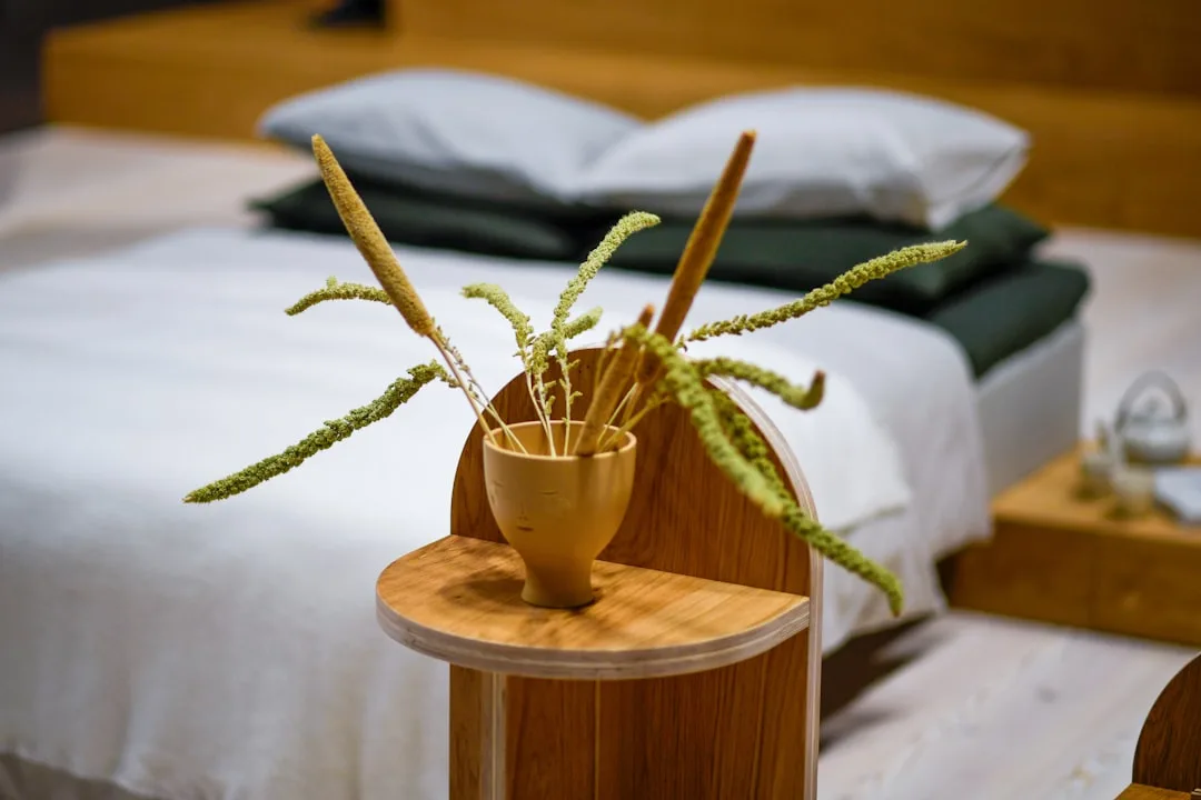 Warm wooden Japanese soaking tub with organic plaster surround and single ceramic vessel
