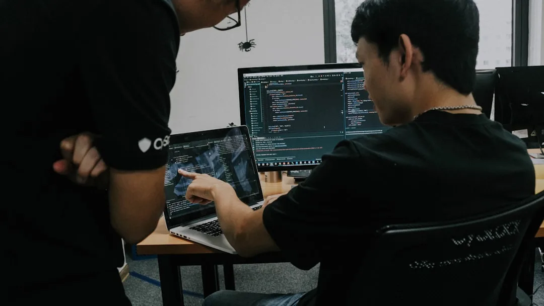 Group of developers in live coding bootcamp session with instructor on video screen