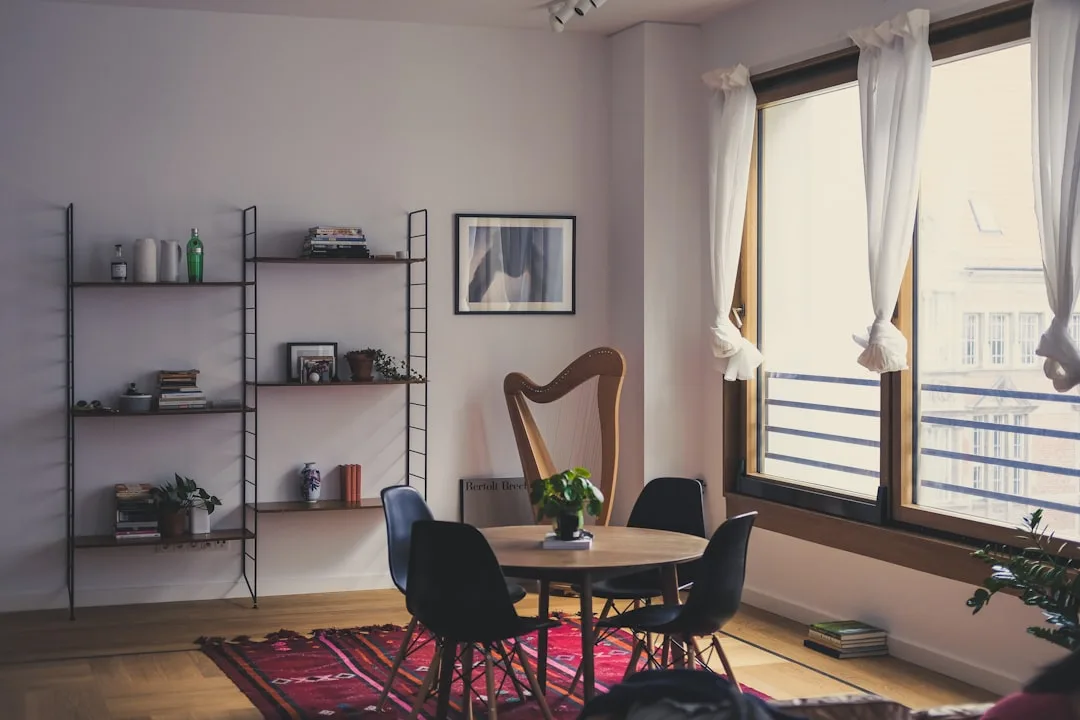 Open concept co-living common area with dining table and social seating zones