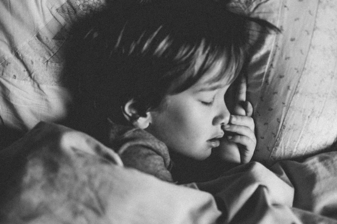 Parent and child in calming bedtime ritual with soft lighting