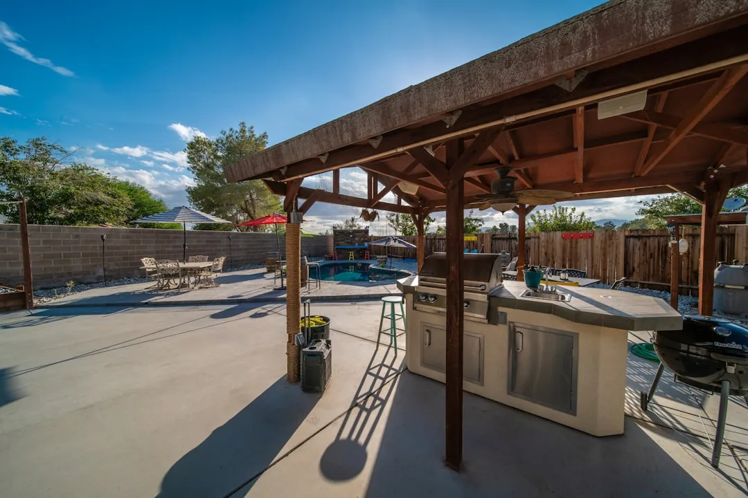 Modular patio kitchen island showing concrete base with stainless appliances